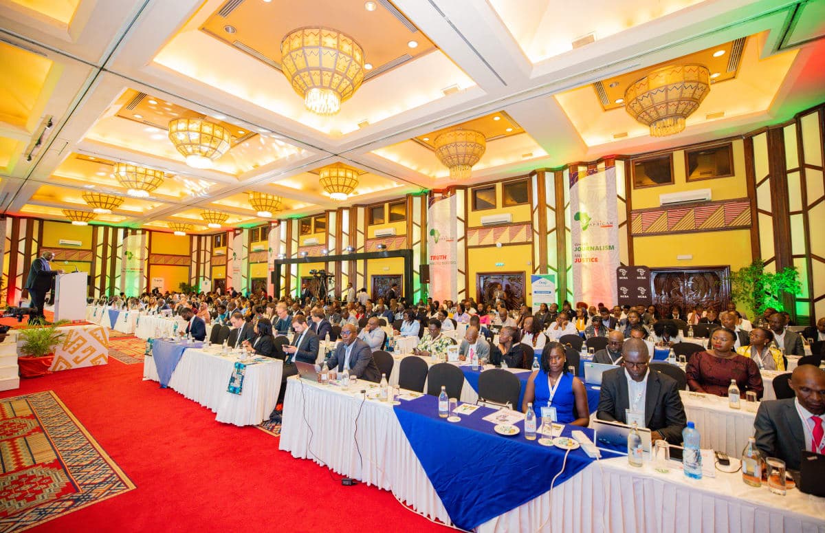 Speaker addressing a packed conference audience