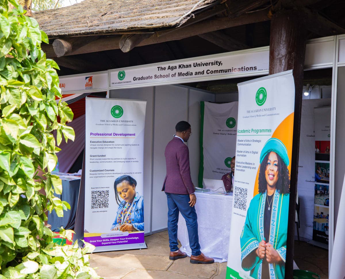 Exhibition visitors engaging with booth staff