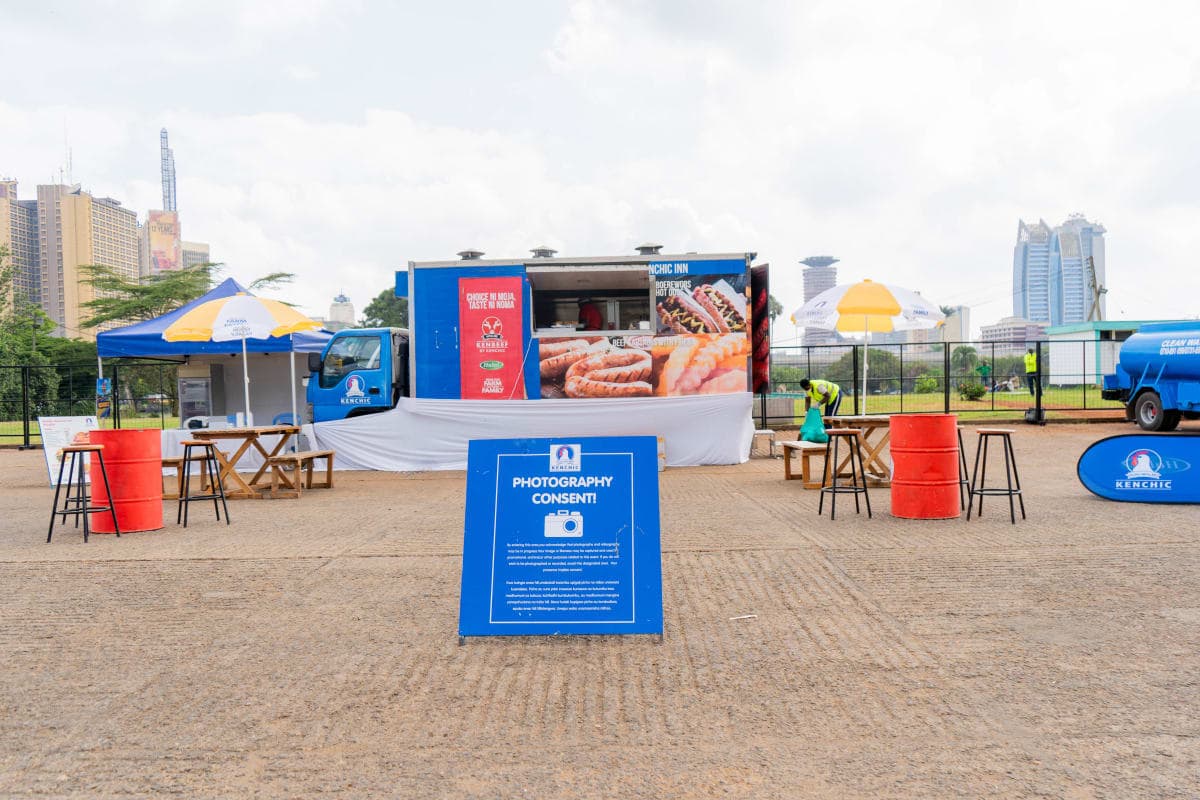 Branded food truck setup with seating area