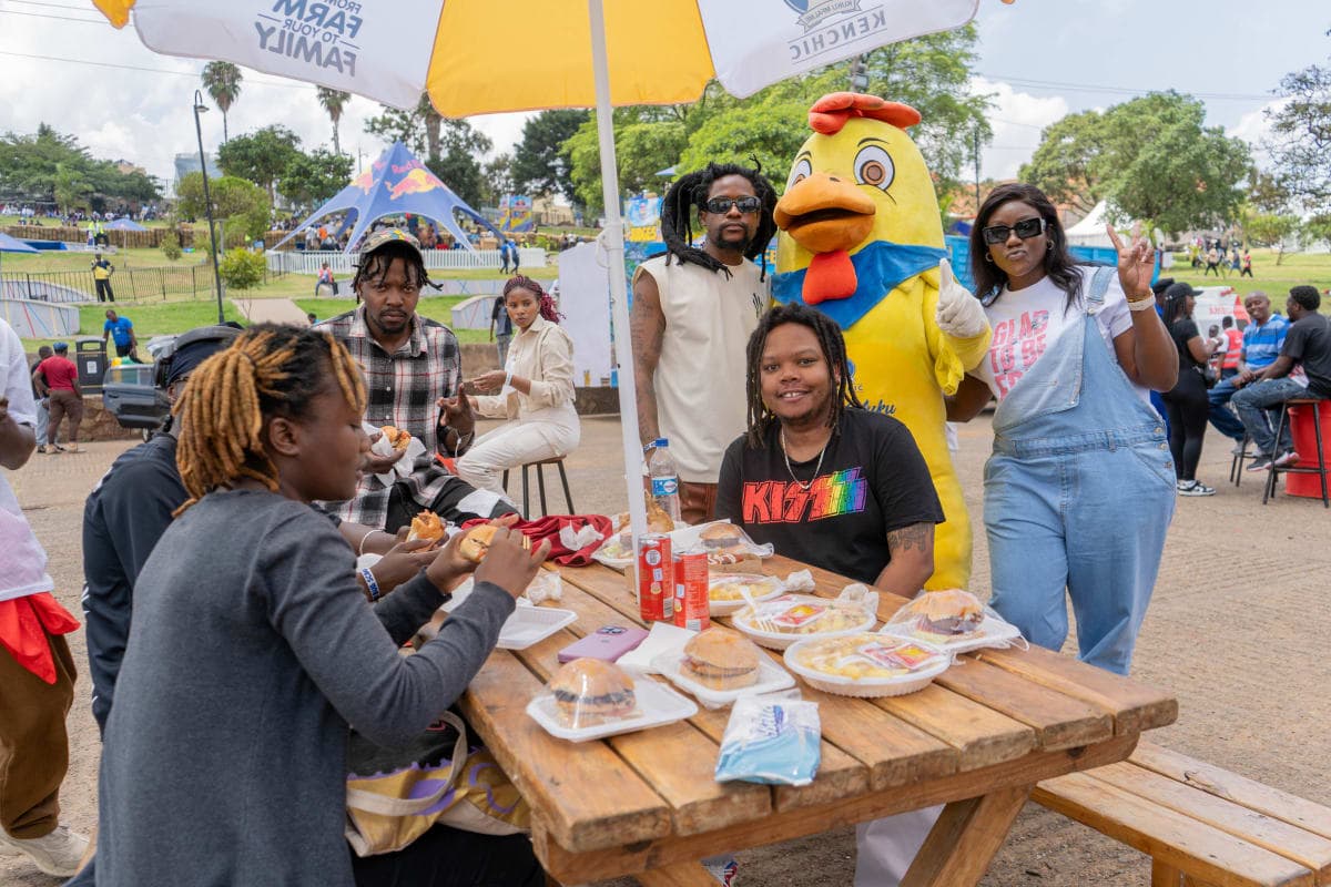 Guests dining with brand mascot at picnic table