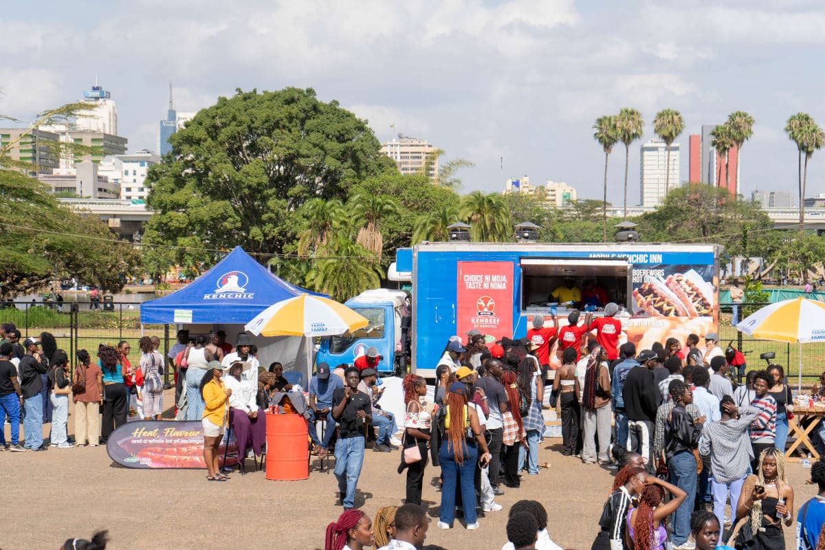Busy outdoor food festival with branded truck